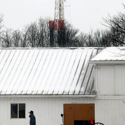 A Chevron rig drills for natural gas behind the property owned by the Mast family of New Wilmington, Lawrence County. Energy companies are leasing land throughout Pennsylvania and Ohio, where Amish families like the Masts live.
