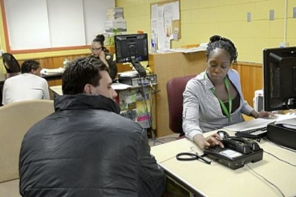 Discharge and release coordinators Asia Pruden, foreground, and Ronele Thomas process former inmates at the Discharge and Release Center on Thursday at the Allegheny County Jail in Pittsburgh.