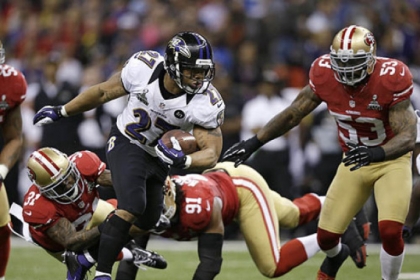 Ravens running back Ray Rice escapes from the 49ers Donte Whitner, Ray McDonald and NaVorro Bowman during the first half of Super Bowl XLVII.
