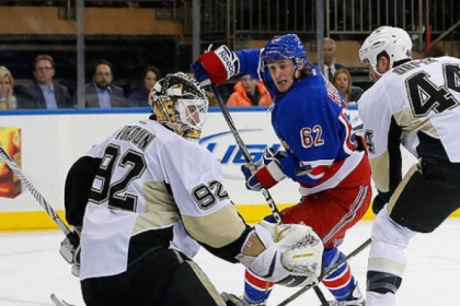 Brooks Orpik helps goalie Tomas Vokoun defend a shot by the Rangers' Carl Hagelin in a Jan. 31 game.