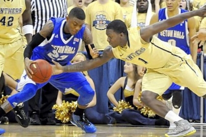 Pitt's Tray Woodall reaches in for the ball against Seton Hall's Fuquan Edwin in the first half at the Petersen Events Center Monday night.