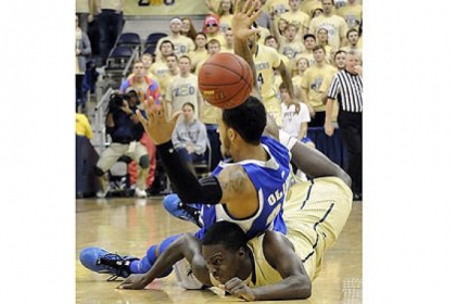 Pitt's Tray Woodall lands underneath Seton Hall's Brian Oliver as the ball bounces on Oliver's head to go out of bounds in the first half Monday night at Petersen Events Center.