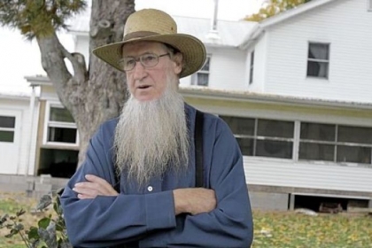 In this 2011 file photo, Sam Mullet stands in front of his home in Bergholz, Ohio.