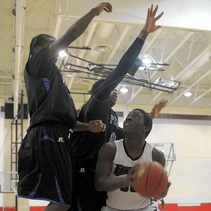 Obama's Lamont Butler, right, waits for an opening to shoot against a Perry double team Tuesday in a City League game.