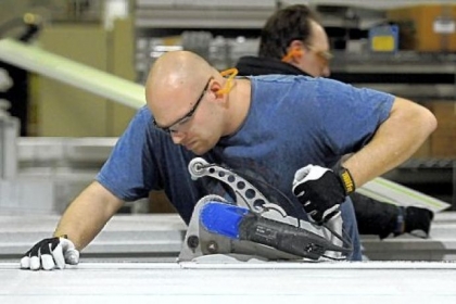 Tom Miovas, front, and Dan Hilliker work on cutting cast polystyrene building panels to fill customer orders at Syntheon.