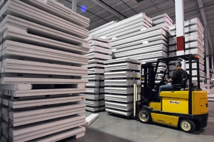 Steel-reinforced cast polystyrene building panels are stacked high at the Syntheon facility in Leetsdale.