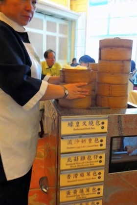 Steamed dumplings are kept hot in carts wheeled from table to table.