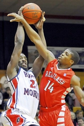 Robert Morris' Lucky Jones takes a foul from Saint Francis' Dom Major in the first half at the Sewall Center Wednesday night.