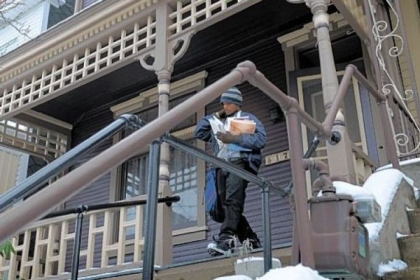 Mail carrier Ahmad Shareef delivers mail Wednesday in Pittsburgh's Bloomfield neighborhood. n Pittsburghers react to the decision to end Saturday mail delivery in a video at post-gazette.com