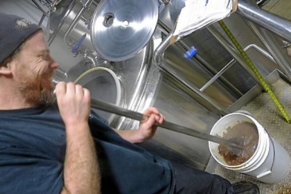 East End Brewing Co.'s Brendan Benson makes a bucket of "hot chocolate" -- mixing in boiling wort to melt broken chunks of Belgian dark chocolate to pour back into the brewing stout.