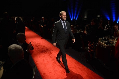 Former Pittsburgh Steelers coach Bill Cowher walks the rent carpet.