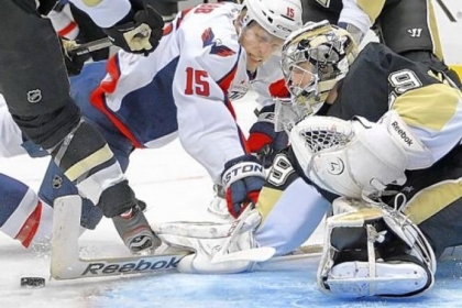 Penguins goalie Marc-Andre Fleury makes a save on the Capitals' Joey Crabb in the second period of Thursday's 5-2 win against Washington.