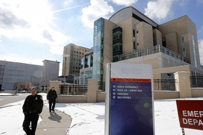 Security guards on Wednesday patrol the sidewalk at a Veterans Affairs hospital in Oakland. Federal health officials now say five people may have died from Legionnaires' disease at local VA hospitals over the past two years.