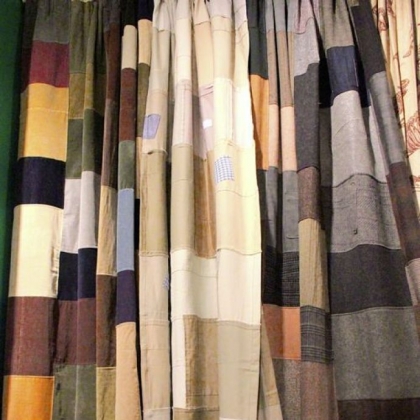 Design Legacy's Goods Made Good line of drapes created from material donated to Goodwill. Men's suiting fabric and corduroy patches are shown.