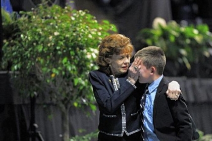 Sue Paterno wipes tears from the face of one of her grandchildren as they leave "A Memorial for Joe" last January at the Bryce Jordan Center on the campus of Penn State University.