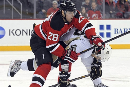 The New Jersey Devils' Anton Volchenkov checks the  Penguins' Brandon Sutter during the first period of this afternoon's game in Newark.