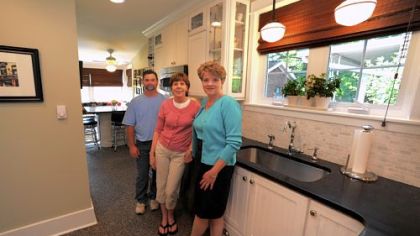 Contractor Scott Bissell of Bissell Contracting, Patty Schlicht and designer Dawn Day in the narrow renovated kitchen at Ms. Schlicht's Squirrel Hill home.