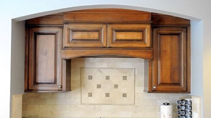The stove area in this Mt. Lebanon kitchen features a travertine marble backsplash.