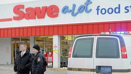 Police investigate the scene outside of a Save-A-Lot food store at Crossroads Plaza in East Huntingdon where a state police trooper on Friday shot and killed a man who had assaulted the trooper.