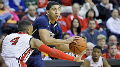 Pitt's James Robinson looks to pass the ball in front of Rutger's Myles Mack during the first half of today's basketball game in Piscataway, N.J.