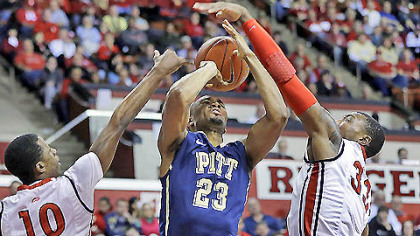 Pitt's Trey Zeigler has his shot blocked by Rutgers defender Wally Judge (33) as Rutgers' Mike Poole (10) helps out during the first half of today's basketball game in Piscataway, N.J.