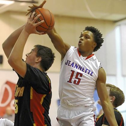Jeannette's Damone Morton blocks a shot by Serra Catholic's George Prota Friday.