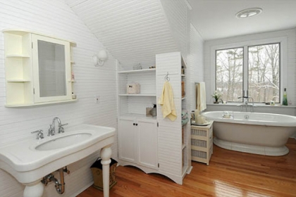 The master bathroom features a soaker tub with a view.