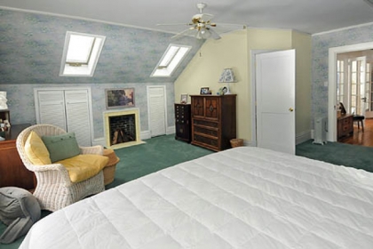 Master bedroom with its angled ceiling and cedar closet and drawers is a lovely retreat.