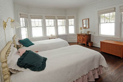 The first-floor bedroom shows off the fine hardwood floors that run throughout the house.