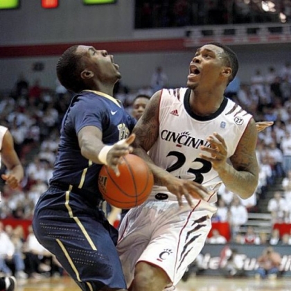 Pitt guard Tray Woodall (1) and Cincinnati guard Sean Kilpatrick (23) collide in the first half Saturday in a Big East Conference game won by the Panthers.