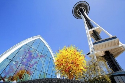 Chihuly Garden and Glass opened under the Space Needle. The work "Pacific Sun" sits in front of The Glasshouse (at left).