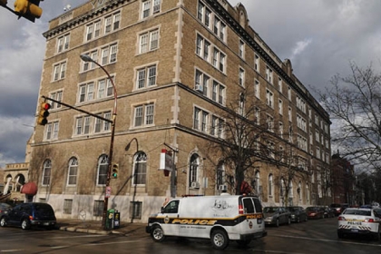 City of Pittsburgh Police vehicles sit in front of the YMCA, along West North Avenue on the Northside. Two bodies were  found in two different apartments at the YMCA.