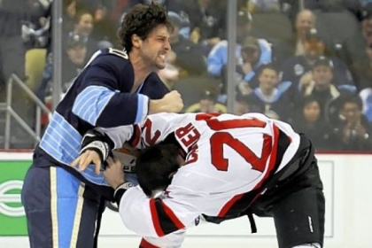 The Penguins' Robert Bortuzzo, left, fights the Devils' Ryan Carter on the opening faceoff.