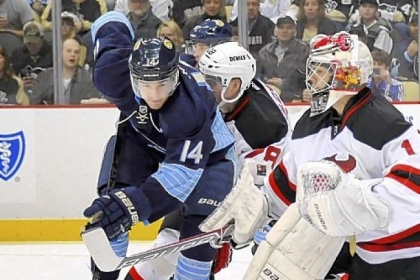 The Penguins' Chris Kunitz can't get the puck on goal against the Devils' Johan Hedberg in the first period Sunday night at Consol Energy Center.