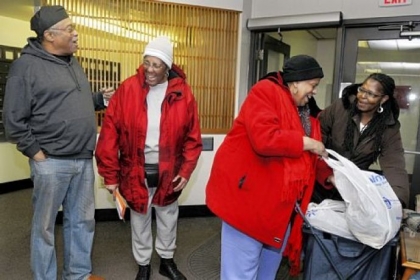 George Gist, left, tenant council president of the K. Leroy Irvis Towers, a low-income high-rise apartment for the elderly, talks with residents and fellow council members Pauline Brown (second from left) and Ora Upsher (third from left), with Angela Howze-Mendoza of the Hill District Consensus Group. Mr. Gist and Ms. Howze-Mendoza have been reaching out to tower residents and advocating for them to help them be part of the larger neighborhood.