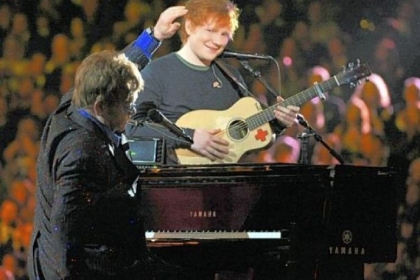 Sir Elton John, left, and Ed Sheeran perform on stage at the 55th annual Grammy Awards.