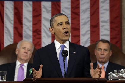 President Barack Obama, flanked by Vice President Joe Biden and House Speaker John Boehner of Ohio, gives his State of the Union address during a joint session of Congress on Capitol Hill in Washington.