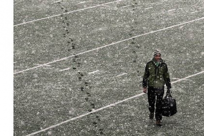 Alex Warzinski, 20, a junior at Carnegie Mellon University and a member of the Ski and Snowboard team, walks across their football field on his way to go skiing in the Laurel Highlands.