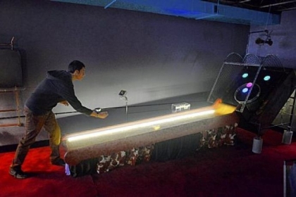 Nick Barletta tries his hand at ski ball, below.