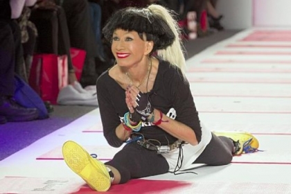 Designer Betsey Johnson greets the audience with her trademark cartwheel and split following a showing of her fall 2013 collection Monday.