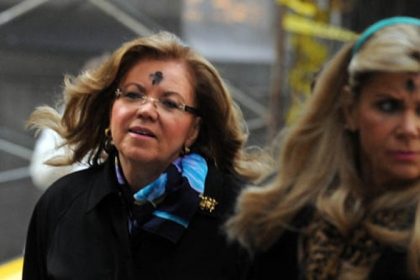 Former State Supreme Court Judge Joan Orie Melvin  makes her way to the Allegheny County Courthouse on the morning of Ash Wednesday. Janine Orie is to the right.