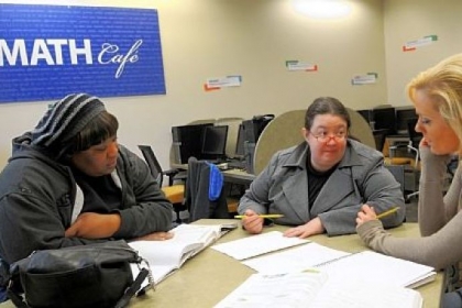 At the Boyce campus of CCAC, Alycia Bencloski-Brashear, center, project coordinator for the Math Cafe; helps students Chiron Emerick, left, and Dana Rozeck, right, learn math concepts.