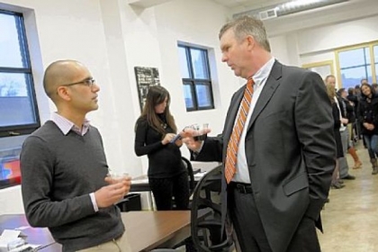 Anup Aryal, left, with the startup Open Curriculum, talks with Tim Devlin, a program director at Allegheny Intermediate Unit, at the grand opening of the Hustle Den Wednesday in East Liberty.