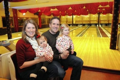 Tatum and Steven Veverka of Hampton sit with their daughters Mia, 3, with Steven, and Macy, 1, at Arsenal Bowling Lanes in Lawrenceville. Steven and Tatum met there nine years ago in a bowling league.