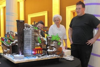 Megan Hart, left, Alice Leich and Patrick Ellis look at "It's a Delicious Day in the Neighborhood!," an edible cake made for CAKEitecture, Heinz Architectural Center's 20th anniversary celebration, at Carnegie Museum of Art on Saturday. Dozen Bakeshop, where Ms. Hart is head cake designer and Mr. Ellis is assistant cake designer, teamed up with the Young Architects Forum to create their Mr. Rogers' Neighborhood-themed cake.