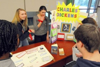 Bailey Baker, left, and Anastasia Crankobic greet visitors to their Charles Dickens project at the Tale of Two Cities Museum.