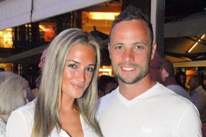 South African sprinter Oscar Pistorius, a double-amputee, stands with his model girlfriend Reeva Steenkamp in Johannesburg on Jan. 26.