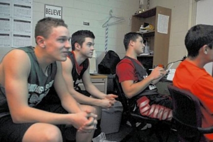 The Fox Chapel High School boys basketball team reviews video before practice Tuesday.