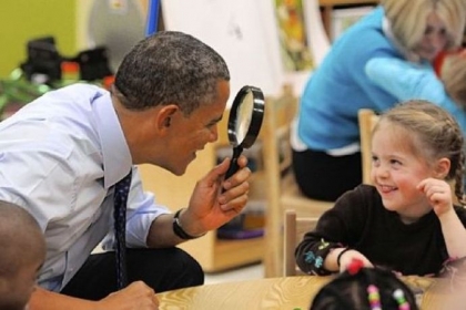 President Barack Obama uses a magnifying glass to play with a young girl Thursday during a visit to College Heights Early Childhood Learning Center in Decatur, Ga. The president is proposing a nationwide initiative for children in pre-kindergarten.