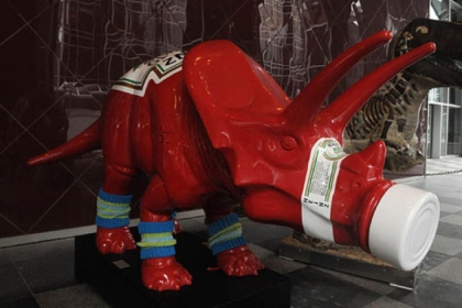 A dinosaur painted as a  "Heinz" ketchup dinosaur  are displayed outside of the One PPG Place.
